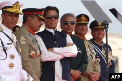 Pakistan's Prime Minister Imran Khan (3L) and President Arif Alvi (3R) watch fighter jets perform during the Pakistan Day parade in Islamabad on March 23, 2022. (Ghulam Rasool / AFP)