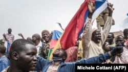 Russians and Malian flags are waved by protesters in Bamako during a demonstration against French influence in the country on May 27, 2021. (Michele Cattani/AFP)