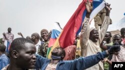 Russians and Malian flags are waved by protesters in Bamako, during a demonstration against French influence in the country on May 27, 2021. (AFP)