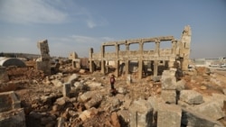 A child stands in the middle of ruins of an ancient building in the archaeological site of Sarjableh, in the northern countryside of Idlib, Syria, November 17, 2021. (Khalil Ashawi/REUTERS))