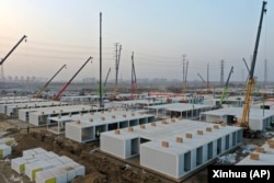 In this aerial photo released by China's Xinhua News Agency, workers build a large centralized quarantine facility capable of holding several thousand people in Shijiazhuang in northern China's Hebei Province, Saturday, Jan. 16, 2021. (Jin Liangkuai/Xinhua via AP)