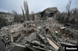 Rescuers work at the site of a hospital's maternity ward destroyed by a Russian missile attack in Vilniansk on November 23, 2022. (Reuters)