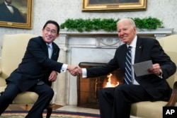 President Joe Biden shakes hands with Japanese Prime Minister Fumio Kishida as they meet in the Oval Office of the White House on January 13, 2023, in Washington, D.C.(Evan Vucci/AP)