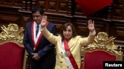 Peru's interim President Dina Boluarte, who was called on by Congress to take the office after the legislature approved the removal of President Pedro Castillo in an impeachment trial, waves after being sworn-in, in Lima, December 7, 2022. (Sebastian Castaneda/Reuters)