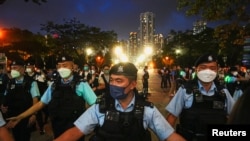 Police officers in Hong Kong disperse people at the closed Victoria Park on the 33rd anniversary of the 1989 crackdown on pro-democracy demonstrations at Beijing's Tiananmen Square, June 4, 2022. (Lam Yik/Reuters)