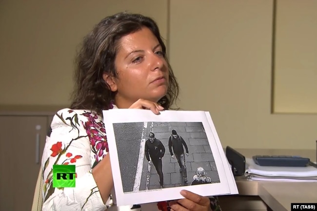 RUSSIA -- RT Editor-in-Chief Margarita Simonyan shows an image of two men during an interview with Aleksandr Petrov and Ruslan Boshirov, who are suspected by the British authorities of poisoning former GRU officer Sergei Skripal and his daughter Yulia.