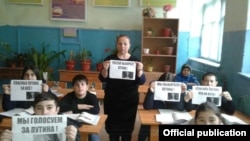 A teacher and her class in Dagestan take part in a pro-Putin action prior to 2018's Russian presidential election. 