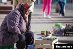 RUSSIA---KALININGRAD/Poor grandma sells homemade canned food on the street/7 APRIL, 2018 Shutterstock