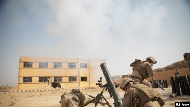 Syria --U.S. Marines fire an M120 Mortar round at a known ISIS target in the Middle Euphrates River Valley Deir ez-Zor province, Syria, Oct. 4, 2018. The coalition forces continue to assist in Operation Roundup, the Syrian Democratic Forces led ground offensive against the Islamid State. (U.S. Army photo by Sgt. Matthew Crane)