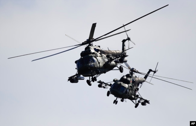 Two Belorussian military helicopters fly during the Zapad military exercises with Russia near Volka, Belarus, September 19, 2017.