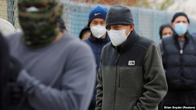 Residents of Chelsea line up for groceries distributed by the Massachusetts Army National Guard amid COVID-19 pandemic.