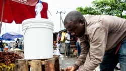 A man washes his hands with chlorinated water at the Mabibo market in Dar es Salaam, Tanzania, on April 16, 2020.