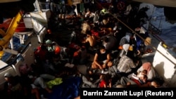 Migrants rest on the deck of the German NGO migrant rescue ship Sea-Watch 3 in international waters north of Libya, in the western Mediterranean Sea, August 2, 2021. (REUTERS/Darrin Zammit)