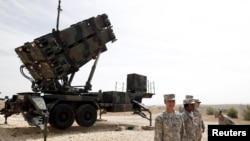 U.S. soldiers stand beside a U.S. Patriot missile system at a Turkish military base in Gaziantep, October 10, 2014.