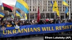 Protesters in Kyiv march against the threat of a new Russian military invasion on Saturday, February 12, 2022.