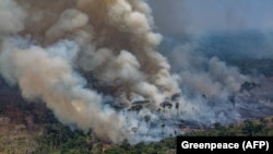 BRAZIL -- Smoke billows from forest fires in the municipality of Candeias do Jamari, close to Porto Velho in Rondonia State, in the Amazon basin, August 24, 2019.
