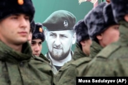 CHECHNYA -- Newly-drafted Chechen conscripts, who were called to service in autumn, stand in front of a portrait of Chechen regional leader Ramzan Kadyrov as they prepare to march in Grozny, November 6, 2018.
