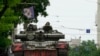Members of Wagner group sit atop of a tank in a street in the city of Rostov-on-Don, on June 24, 2023. President Vladimir Putin said an armed mutiny by Wagner mercenaries was a "stab in the back" and that the group's chief Yevgeny Prigozhin had betrayed Russia. (AFP)