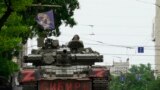 Members of Wagner group sit atop of a tank in a street in the city of Rostov-on-Don, on June 24, 2023. President Vladimir Putin said an armed mutiny by Wagner mercenaries was a "stab in the back" and that the group's chief Yevgeny Prigozhin had betrayed Russia. (AFP)