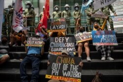Activists protest outside the Chinese Consulate in Makati City on July 12, 2021. The protest marked the fifth anniversary of The Hague ruling invalidating Beijing's sweeping claims over the South China Sea. (Reuters)