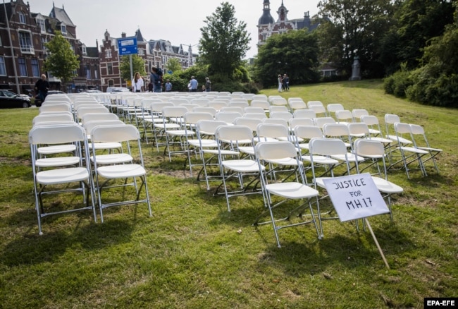 NETHERLANDS -- White chairs and a placard are set up by relatives of crash victims of flight MH17 as a silent protest in front of the Russian embassy in The Hague, May 8, 2018