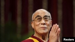The Dalai Lama gestures before speaking to students during a talk at Mumbai University in this February 18, 2011. (Danish Siddiqui/Reuters)