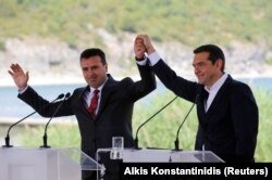 Greek Prime Minister Alexis Tsipras and Macedonian Prime Minister Zoran Zaev gesture before the signing of an accord to settle a long dispute over the former Yugoslav republic's name in the village of Psarades, in Prespes, Greece, June 17, 2018. REUTERS/A