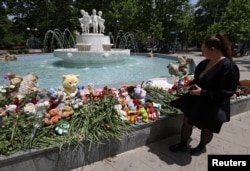 A woman visits a makeshift memorial to victims of what Russian authorities say was a Ukrainian missile strike in Sevastopol, Russian-occupied Crimea, on June 24, 2024.(Alexey Pavlishak/Reuters)