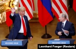 FINLAND -- U.S. President Donald Trump and Russian President Vladimir Putin react at the end of the joint news conference after their meeting in Helsinki, July 16, 2018.