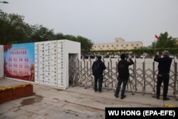 Foreign journalists take photos and video outside a location in Xinjiang on April 22, 2020, that was earlier identified as a re-education facility by an Australian think tank.