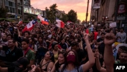 CHILE – Demonstrators gather in Santiago, on October 25, 2019, a week after protests started. Demonstrations against a hike in metro ticket prices in Chile's capital exploded into violence on October 18, unleashing widening protests over living costs and social inequality.
