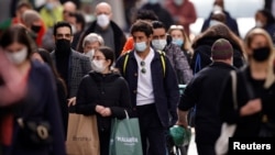 People wearing protective masks walk in the Montorgueil street in Paris amid the coronavirus disease (COVID-19) outbreak in France, February 25, 2021. REUTERS/Sarah Meyssonnier 