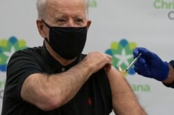 Then U.S. President-elect Joe Biden receives the second course of the Pfizer-BioNTech Covid-19 vaccine on Jan. 11, 2021 at Christiana Hospital in Newark, Delaware, administered by Chief Nurse Executive Ric Cuming.