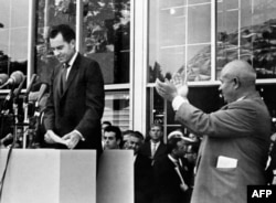 USSR -- US vice president Richard Nixon (L) being applauded by Soviet leader Nikita Khrushchev (R) after he delivered a speech during a visit at the American National Exhibition on July 27, 1959