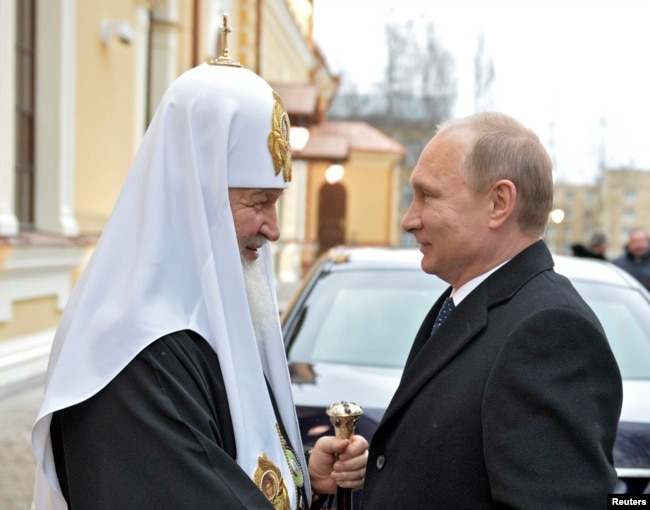 Russia's President Vladimir Putin (R) speaks with Patriarch of Moscow and All Russia Kirill during a visit to St. Sergius of Radonezh Cathedral in Tsarskoye Selo, outside St. Petersburg, December 8, 2014