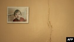 Oksana Novikova is on the wall of a room in an orphanage for HIV positive kids in Moscow, June 13, 2006. AFP PHOTO / MAXIM MARMUR