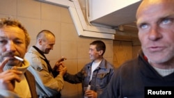 Russian alcoholics share a drink with a migrant worker in a highway underpass in Moscow, 2011. Experts say Russian public health is worse in times of heavy alcohol consumption.