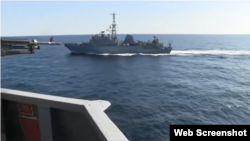 In the first video clip, the Russian ship is to the starboard side of the USS Farragut. It is not clear if the ships' courses would intersect or if they were running parallel at this point.