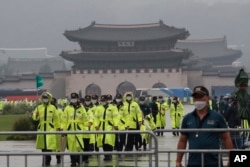 Police officers wearing face masks to help protect against the spread of the coronavirus patrol around the Gyeongbok Palace, one of South Korea's well-known landmarks, in Seoul, South Korea, Saturday, Aug. 15, 2020.