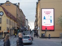 A billboard informing about the importance of social distancing, to prevent the spread of the coronavirus disease (COVID-19), is seen on a facade in Stockholm, Sweden April 29, 2020.