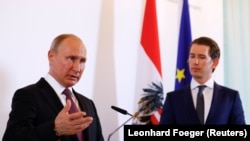 AUSTRIA -- Russian President Vladimir Putin gestures during a joint news conference with Austrian Chancellor Sebastian Kurz in Vienna, June 5, 2018
