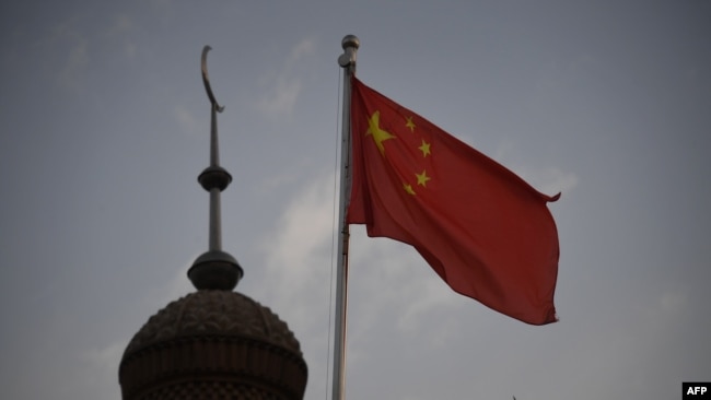 CHINA – Chinese flag flying over the Juma mosque in the restored old city area of Kashgar, in China's western Xinjiang region, on June 4, 2019.