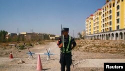 CHINA – A Chinese police officer takes his position by the road near what is officially called a vocational education centre in Yining in Xinjiang Uighur Autonomous Region, China, on Sept. 4, 2018.