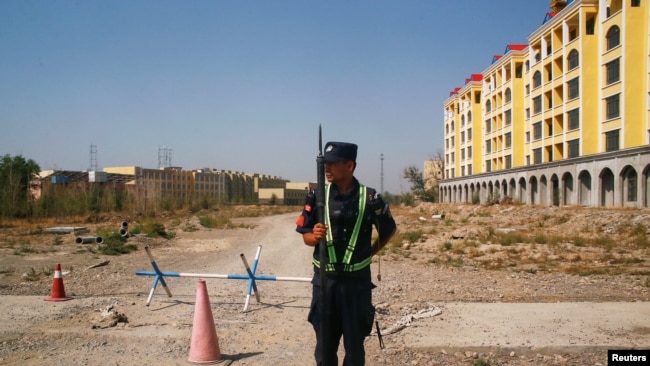CHINA – A Chinese police officer takes his position by the road near what is officially called a vocational education centre in Yining in Xinjiang Uighur Autonomous Region, China, on Sept. 4, 2018.