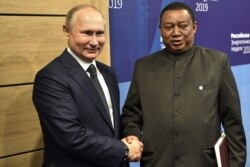 RUSSIA -- Russian President Vladimir Putin and OPEC Secretary-General Mohammed Barkindo meet on the sidelines of the 2019 Russian Energy Week forum in Moscow, October 2, 2019