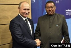 RUSSIA -- Russian President Vladimir Putin and OPEC Secretary-General Mohammed Barkindo meet on the sidelines of the 2019 Russian Energy Week forum in Moscow, October 2, 2019
