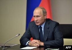 Russian President Vladimir Putin gives a command to destroy the last chemical ammunition from Russia's chemical weapon stockpile via a video conference, September 27, 2017.