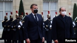French President Emmanuel Macron welcomes Egyptian President Abdel-Fatteh el-Sissi at the Elysee Palace in Paris during his official visit to France, December 7, 2020.