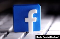 A 3D-printed Facebook logo is seen placed on a keyboard in this illustration taken March 25, 2020.