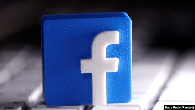 A 3D-printed Facebook logo is seen placed on a keyboard in this illustration taken March 25, 2020.